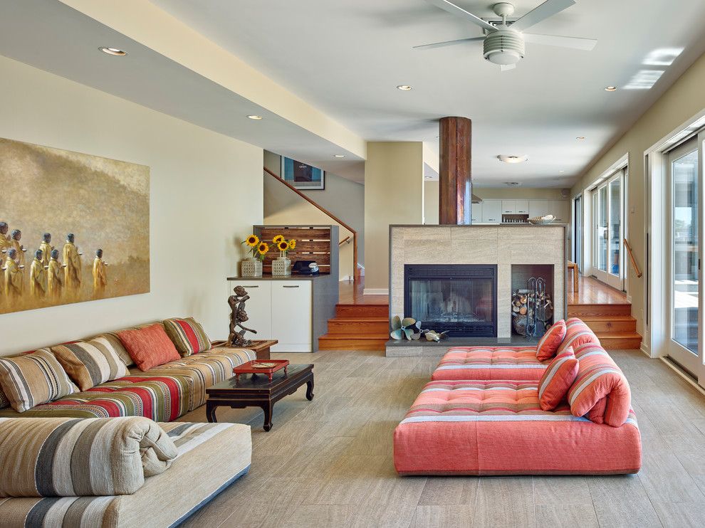 Photo of a beach style formal open concept living room in New York with beige walls, a standard fireplace and beige floor.