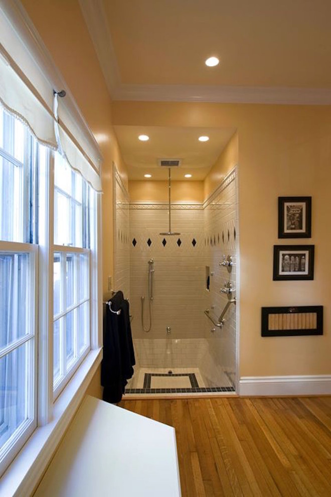 Design ideas for a mid-sized traditional master bathroom in Other with an alcove shower, black tile, black and white tile, white tile, porcelain tile, yellow walls, medium hardwood floors, brown floor, an open shower, raised-panel cabinets, white cabinets, a two-piece toilet, an undermount sink and engineered quartz benchtops.