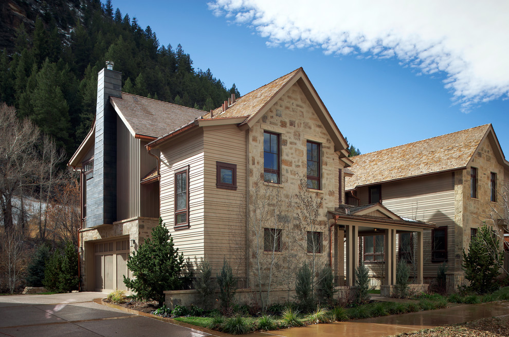 This is an example of a mid-sized traditional three-storey exterior in Denver with wood siding.