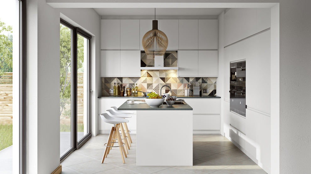 This is an example of a mid-sized contemporary u-shaped separate kitchen in London with an undermount sink, flat-panel cabinets, white cabinets, multi-coloured splashback, black appliances and a peninsula.
