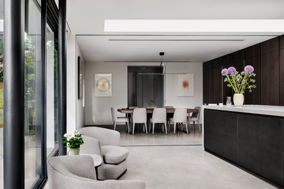 Свежая идея для дизайна: большая гостиная-столовая в стиле модернизм с белыми стенами, бетонным полом, серым полом, многоуровневым потолком и панелями на части стены - отличное фото интерьера