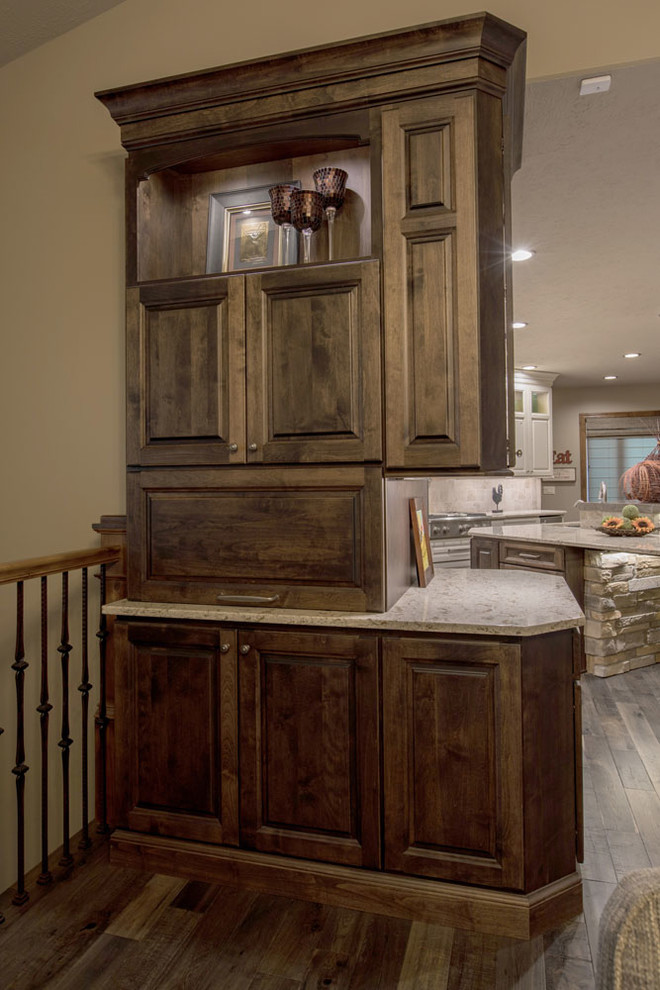 Example of a mid-sized transitional open concept kitchen design with raised-panel cabinets, white cabinets, quartz countertops, stainless steel appliances and an island