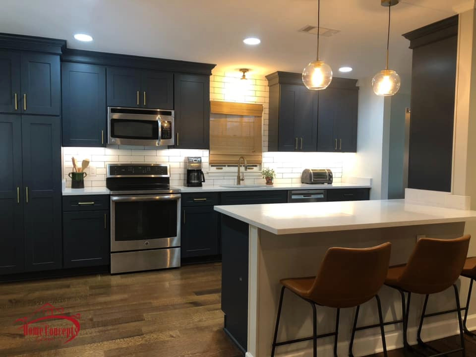 Example of a mid-sized transitional galley medium tone wood floor open concept kitchen design with an undermount sink, shaker cabinets, blue cabinets, quartzite countertops, white backsplash, ceramic backsplash, stainless steel appliances, a peninsula and white countertops