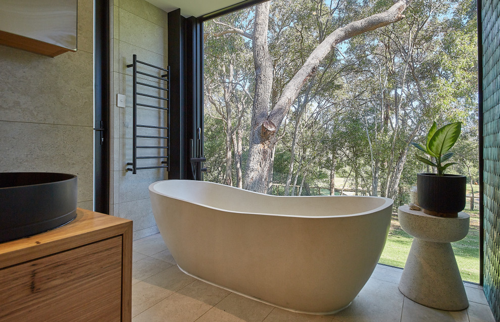Large contemporary master bathroom in Perth with furniture-like cabinets, medium wood cabinets, a freestanding tub, a double shower, a one-piece toilet, beige tile, porcelain tile, white walls, porcelain floors, a vessel sink, wood benchtops, beige floor, an open shower, a niche, a double vanity and a floating vanity.