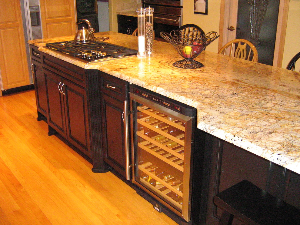 Example of a mountain style kitchen design in Seattle with raised-panel cabinets, black cabinets, granite countertops and an island