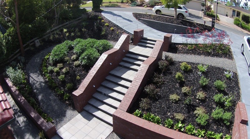 Photo of a mid-sized mediterranean front yard partial sun driveway for summer in Adelaide with a garden path and mulch.