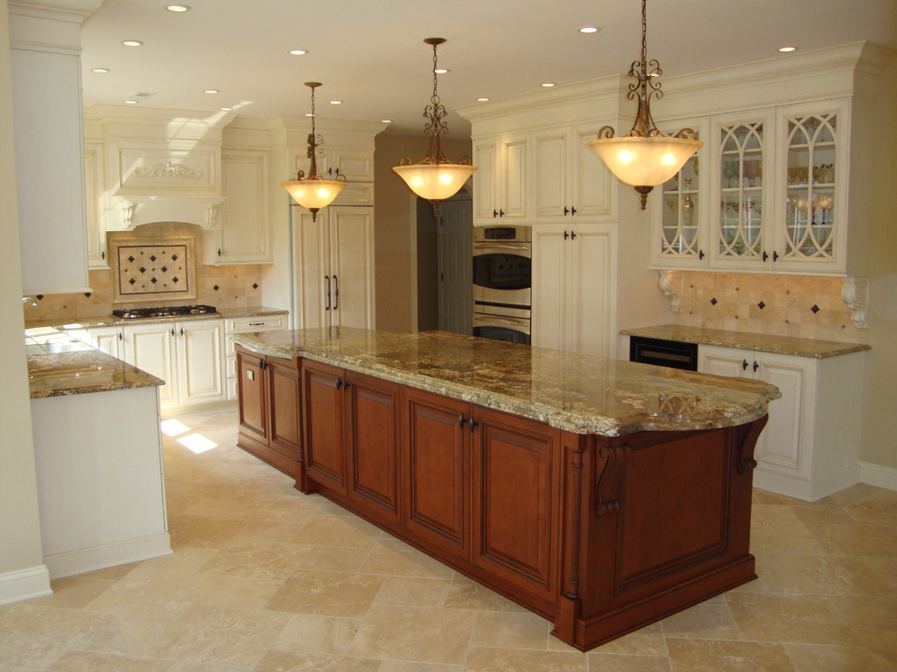 Large traditional u-shaped separate kitchen in Philadelphia with raised-panel cabinets, white cabinets, granite benchtops, beige splashback, travertine splashback, panelled appliances, travertine floors, with island, brown floor and brown benchtop.