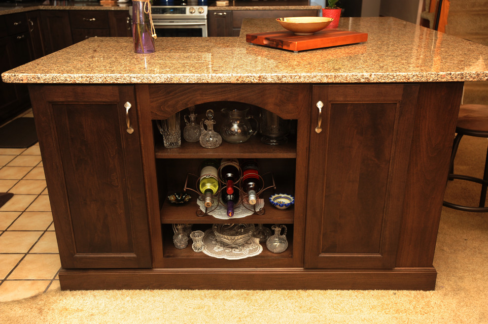 Inspiration for a mid-sized transitional l-shaped ceramic tile eat-in kitchen remodel with an undermount sink, recessed-panel cabinets, dark wood cabinets, granite countertops, multicolored backsplash, glass tile backsplash, stainless steel appliances and an island