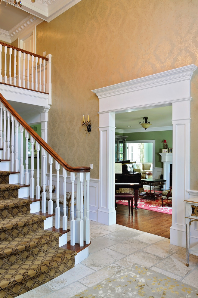 Inspiration for a large traditional wood straight staircase in New York with painted wood risers.