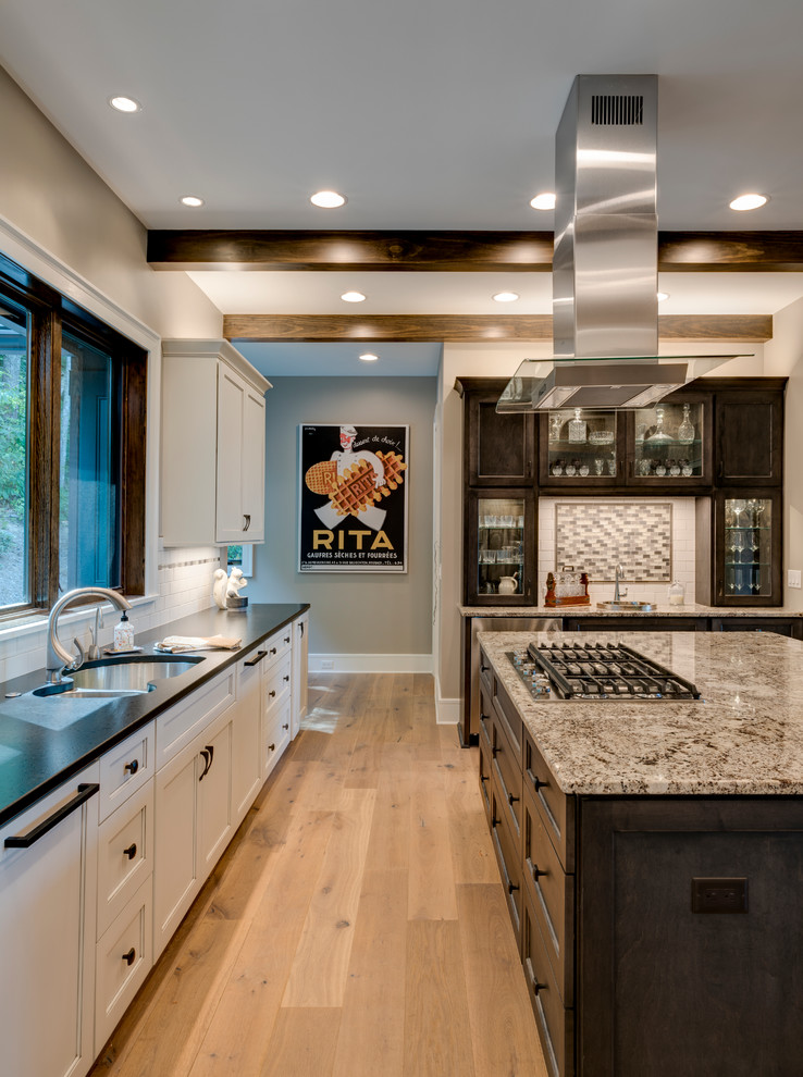 Inspiration for a large arts and crafts eat-in kitchen in Other with an undermount sink, shaker cabinets, white cabinets, granite benchtops, stainless steel appliances, with island and black benchtop.