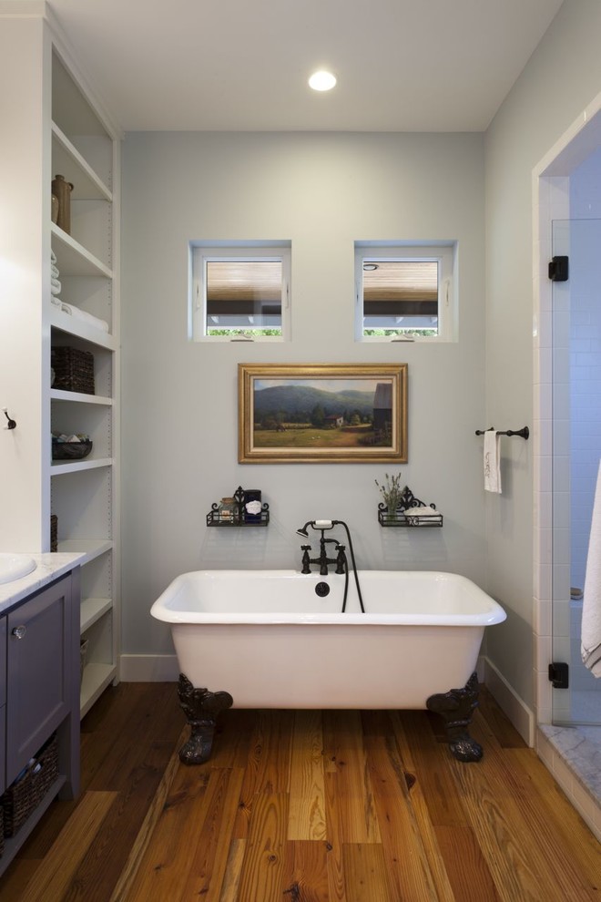 Photo of a country bathroom in Austin with a claw-foot tub.