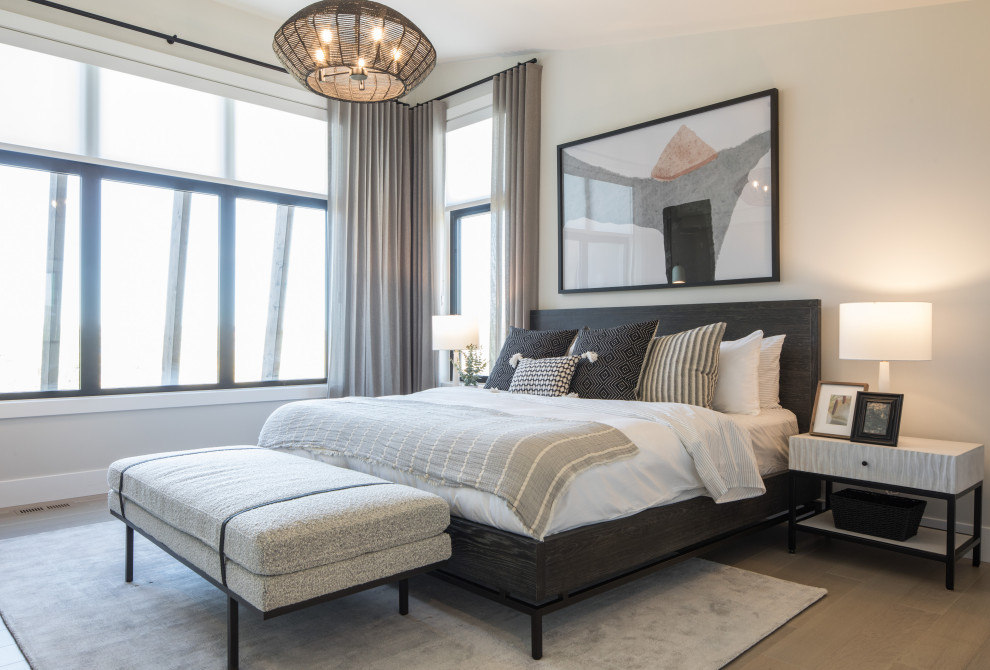 Inspiration for an expansive modern master bedroom in Calgary with white walls and beige floor.