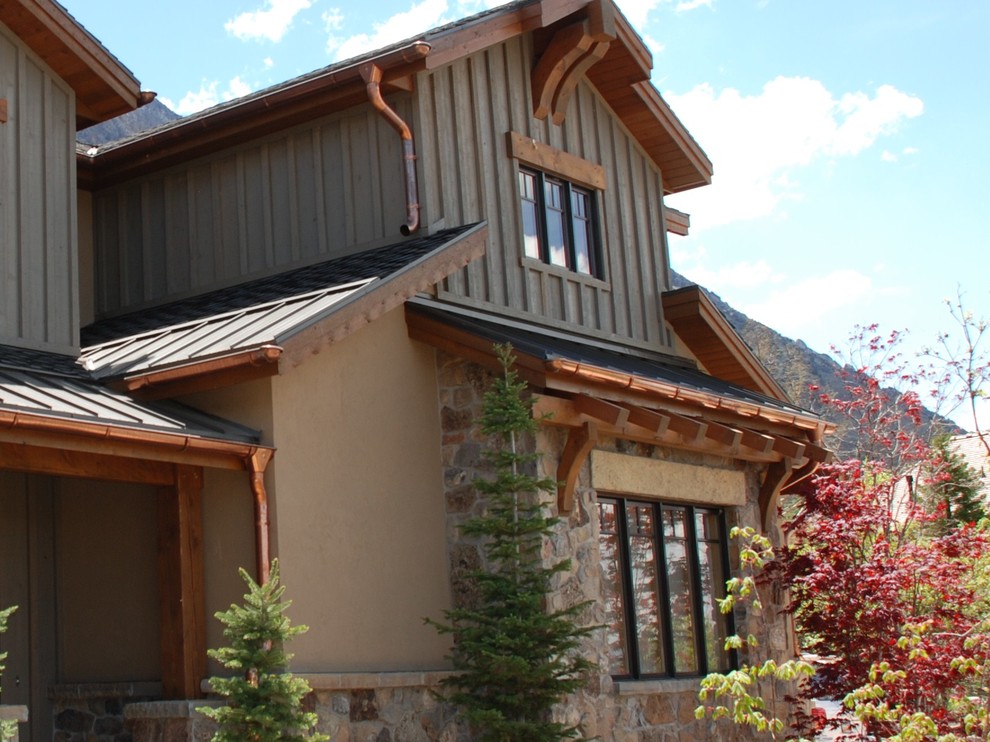 This is an example of a large country two-storey grey house exterior in Salt Lake City with mixed siding, a clipped gable roof and a shingle roof.