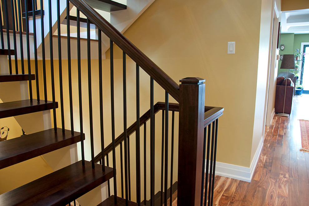 Contemporary wood straight staircase in Ottawa with open risers.