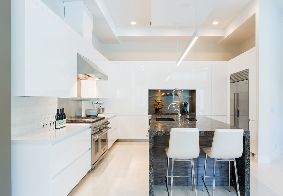 Inspiration for a large contemporary u-shaped separate kitchen in Miami with an undermount sink, flat-panel cabinets, white cabinets, quartzite benchtops, white splashback, porcelain splashback, stainless steel appliances, porcelain floors and with island.