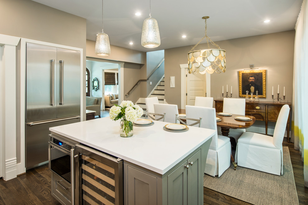 Kitchen - transitional dark wood floor kitchen idea in Austin with a farmhouse sink, shaker cabinets, gray cabinets, white backsplash, porcelain backsplash, stainless steel appliances and an island