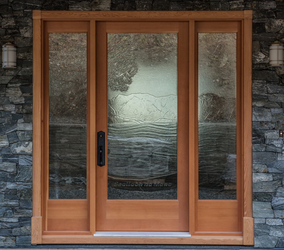 Single front door - large coastal single front door idea with a medium wood front door