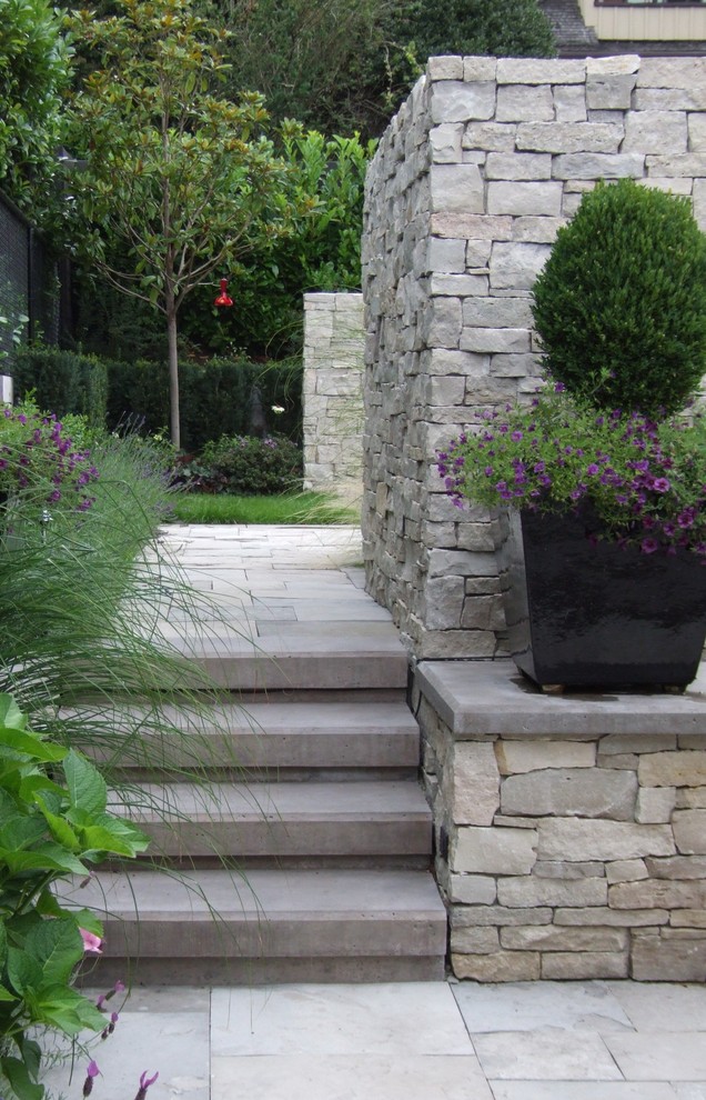 Photo of a contemporary garden in Vancouver with natural stone pavers.