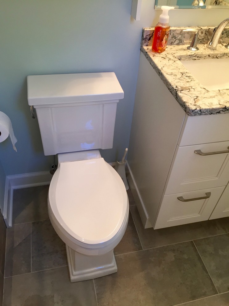 Example of a small transitional master gray tile and porcelain tile porcelain tile home design design in DC Metro with shaker cabinets, white cabinets, a two-piece toilet, green walls, an undermount sink and quartz countertops