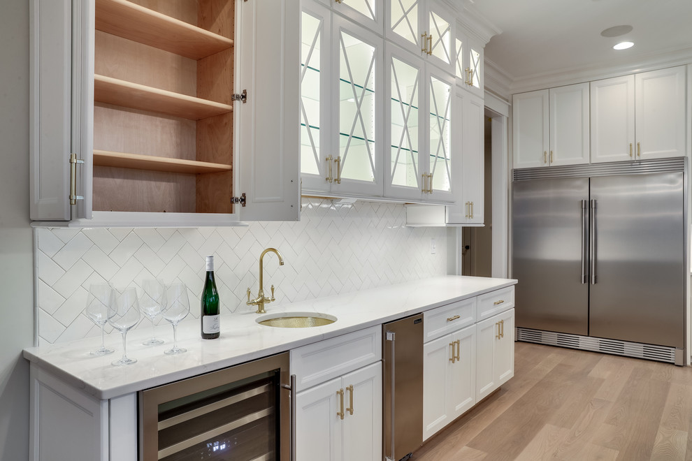 Huge transitional kitchen photo in Baltimore with flat-panel cabinets, white cabinets, marble countertops, white backsplash, subway tile backsplash, stainless steel appliances and an island