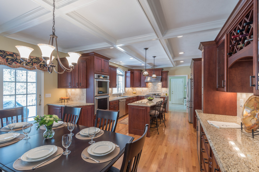 Inspiration for a large transitional light wood floor kitchen remodel in Boston with an undermount sink, medium tone wood cabinets, granite countertops, stone tile backsplash, stainless steel appliances and an island