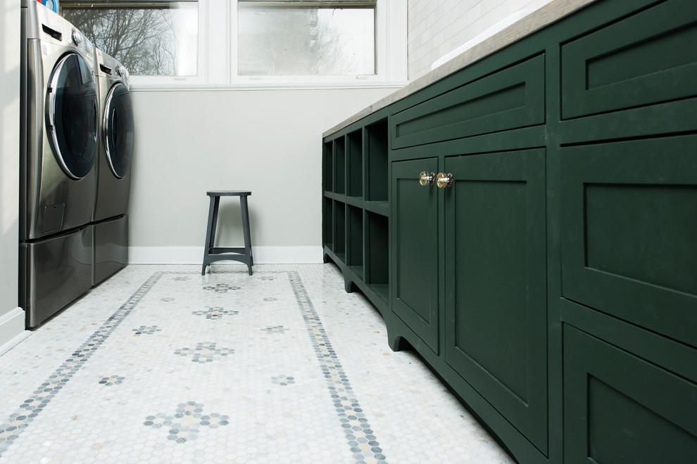 Inspiration for a mid-sized traditional galley dedicated laundry room in Indianapolis with a drop-in sink, shaker cabinets, green cabinets, wood benchtops, green walls, marble floors, a side-by-side washer and dryer and white floor.