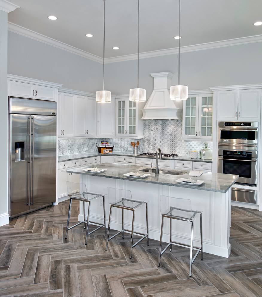 Design ideas for a transitional l-shaped kitchen in Tampa with an undermount sink, recessed-panel cabinets, white cabinets, multi-coloured splashback, stainless steel appliances and with island.
