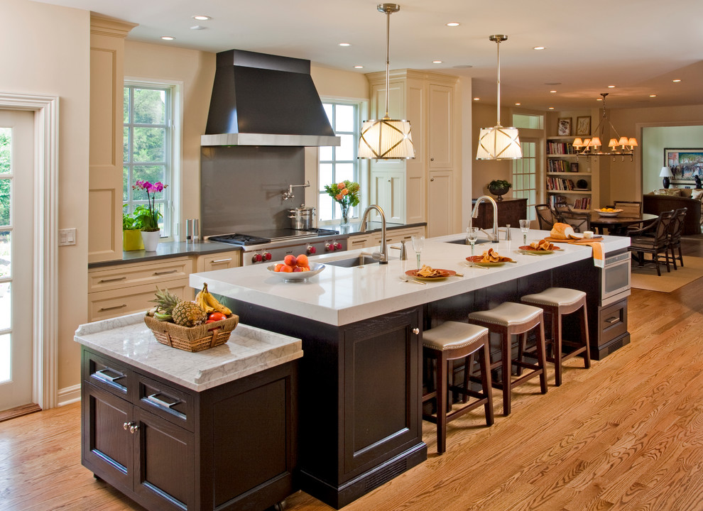 Inspiration for a traditional eat-in kitchen in Philadelphia with an undermount sink, recessed-panel cabinets, dark wood cabinets and stainless steel appliances.