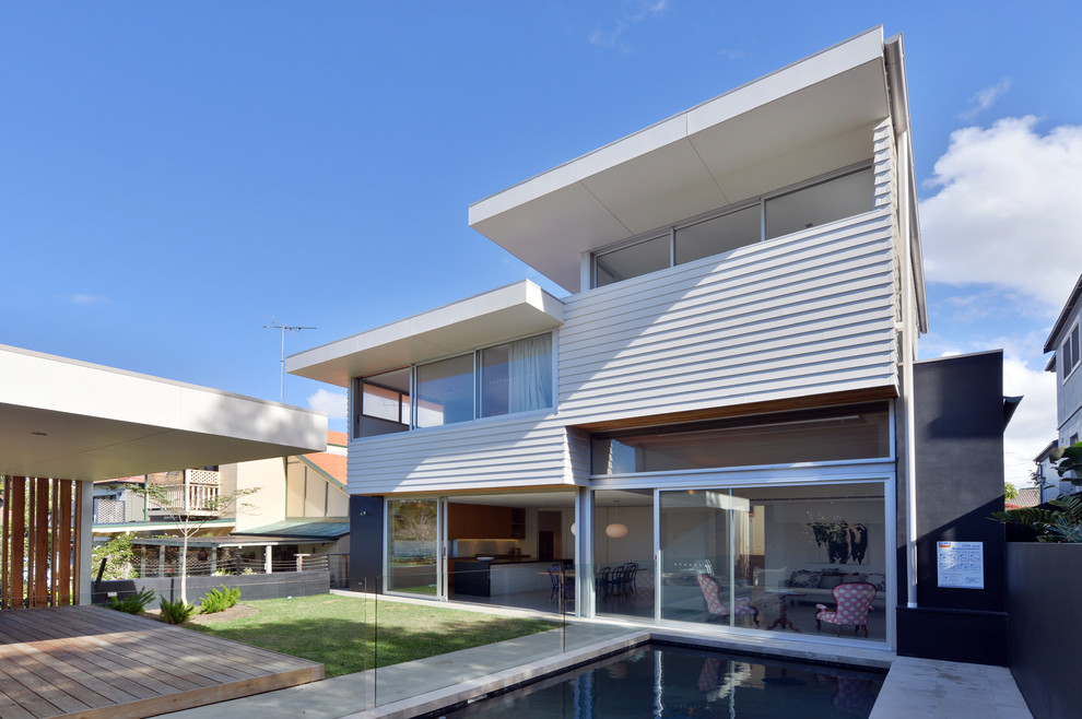 Photo of a contemporary split-level exterior in Sydney with mixed siding and a flat roof.