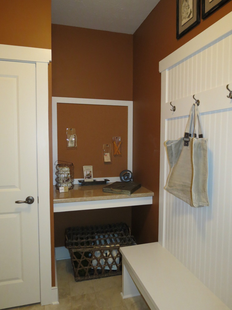 This is an example of a mudroom with orange walls.