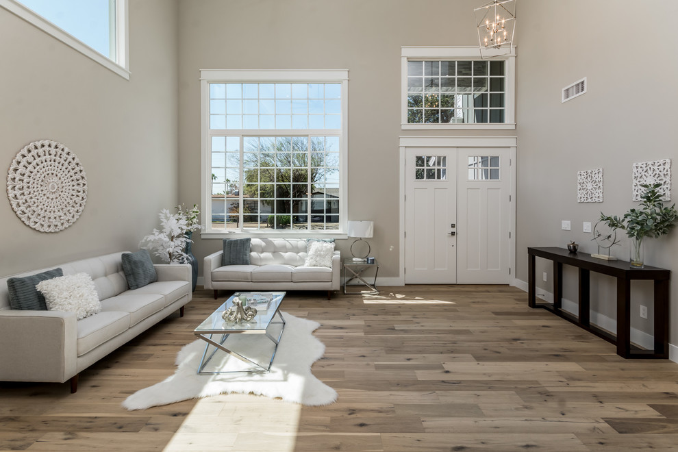 Inspiration for a transitional foyer in Phoenix with beige walls, medium hardwood floors, a single front door, a white front door and brown floor.