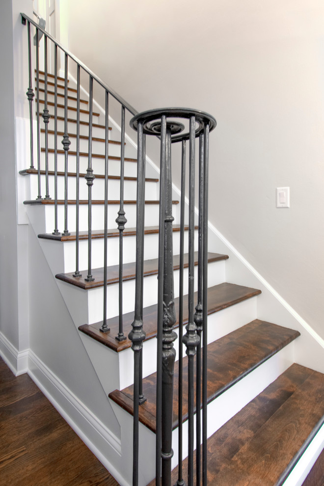 Inspiration for a small transitional wood straight staircase in Milwaukee with wood risers and metal railing.