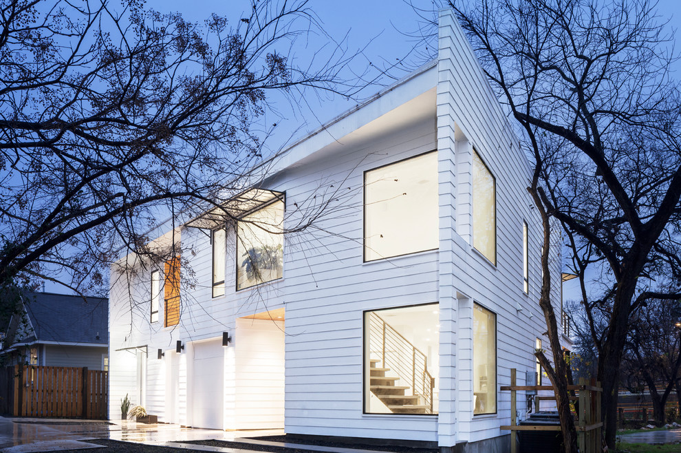 Modern two-storey white duplex exterior in Austin with wood siding and clapboard siding.