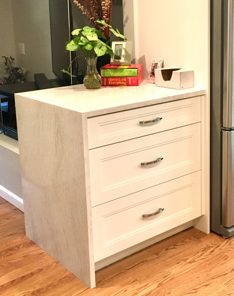 Inspiration for a small transitional u-shaped medium tone wood floor and brown floor enclosed kitchen remodel in Denver with a drop-in sink, shaker cabinets, white cabinets, quartz countertops, gray backsplash, subway tile backsplash, stainless steel appliances, a peninsula and white countertops