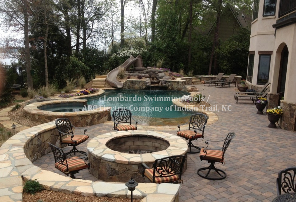 Mid-sized backyard tile and custom-shaped water slide photo in Charlotte