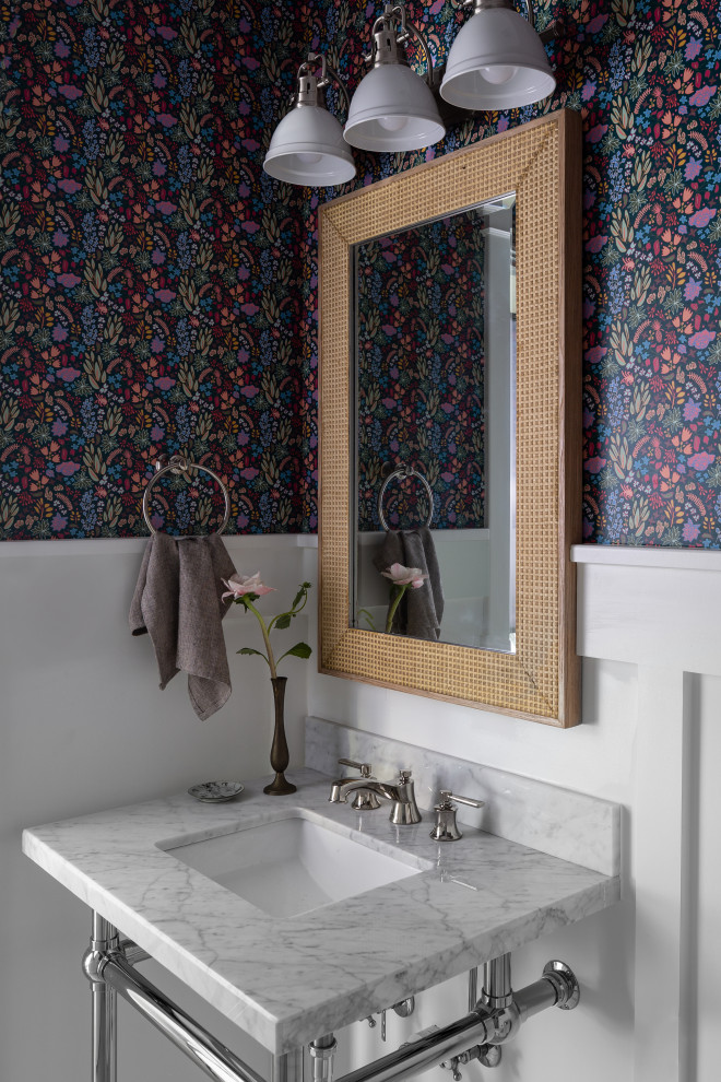 Photo of a traditional cloakroom in DC Metro with porcelain flooring, a console sink, marble worktops, a freestanding vanity unit and wallpapered walls.