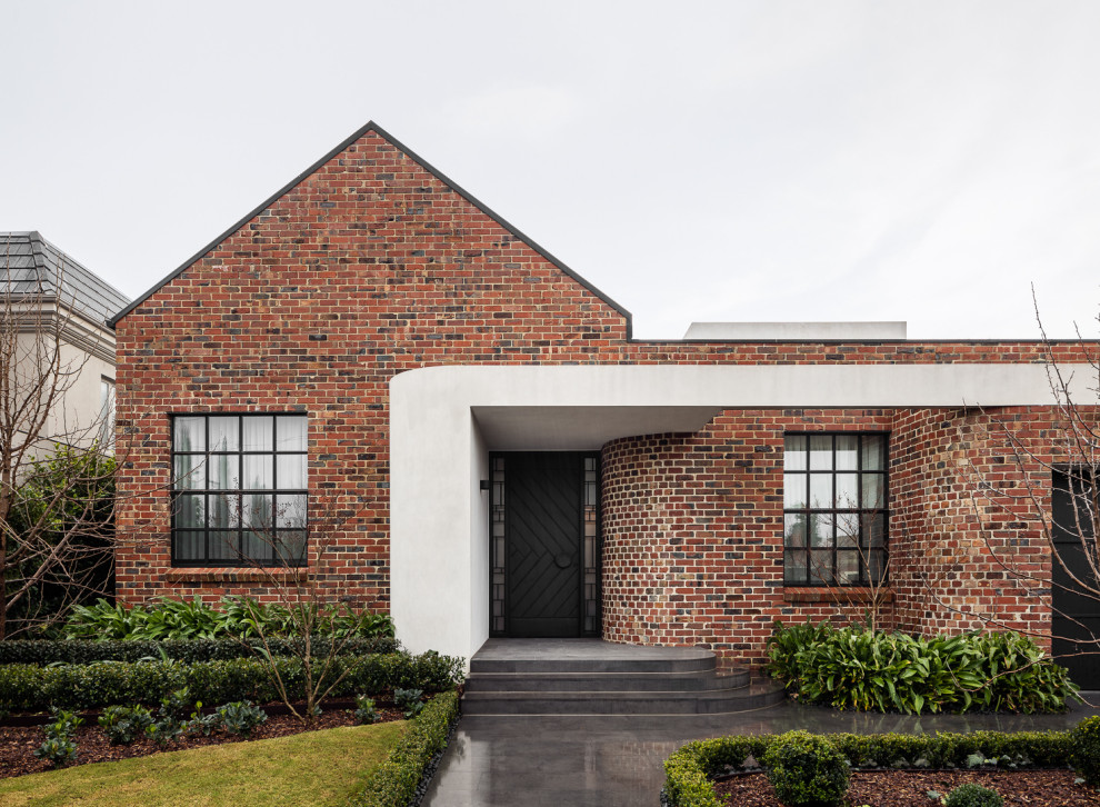 Photo of a large contemporary two floor brick and front detached house in Melbourne with a metal roof.