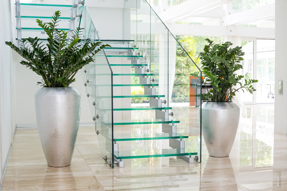 Mid-sized contemporary glass u-shaped staircase in Saint Petersburg with open risers.