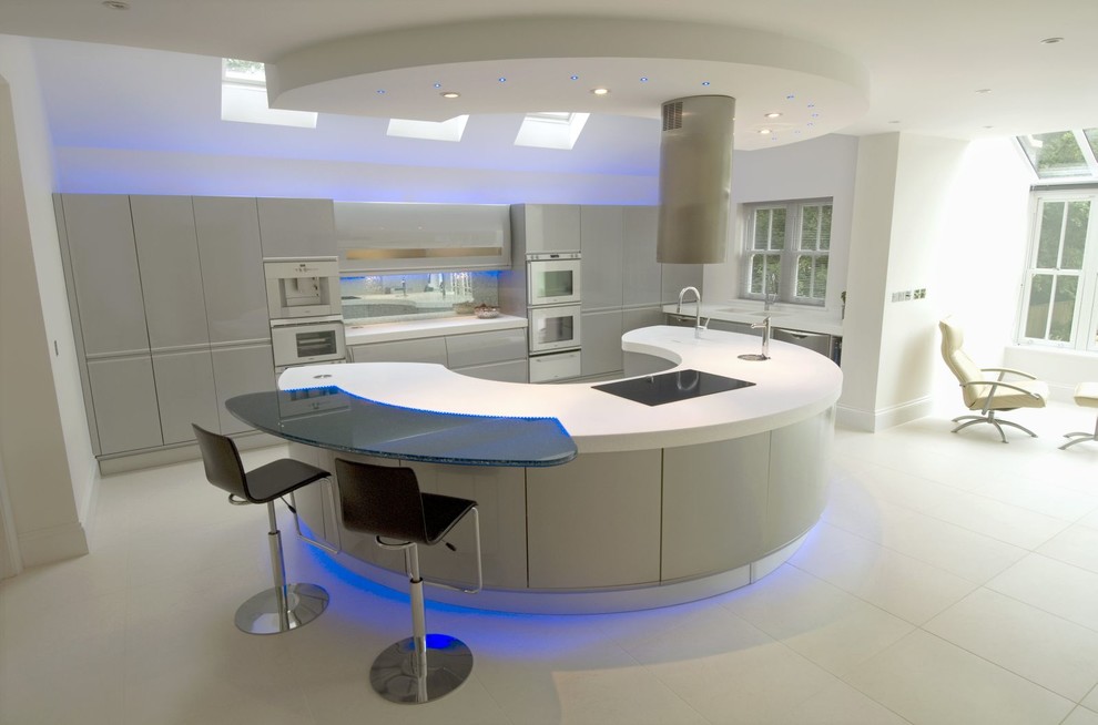 Design ideas for an expansive modern u-shaped eat-in kitchen in London with an integrated sink, flat-panel cabinets, grey cabinets, solid surface benchtops, multi-coloured splashback, glass sheet splashback, stainless steel appliances, porcelain floors and with island.