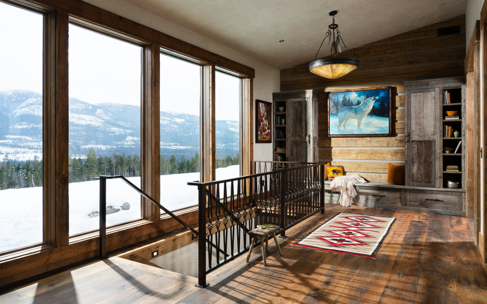 Example of a mountain style dark wood floor, brown floor and wood wall hallway design with brown walls