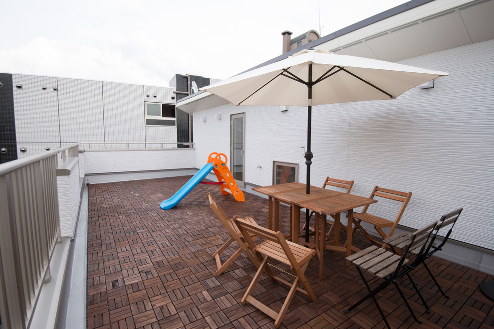 This is an example of a mid-sized modern courtyard patio in Other with decking and no cover.
