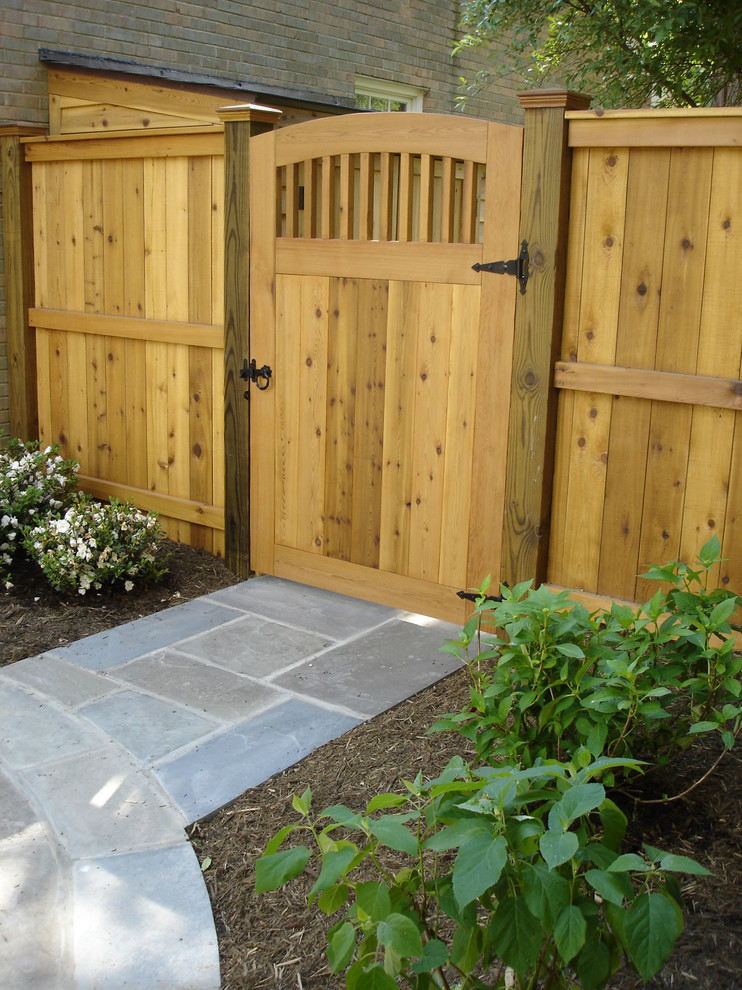 Small traditional backyard garden in DC Metro with a garden path and natural stone pavers.