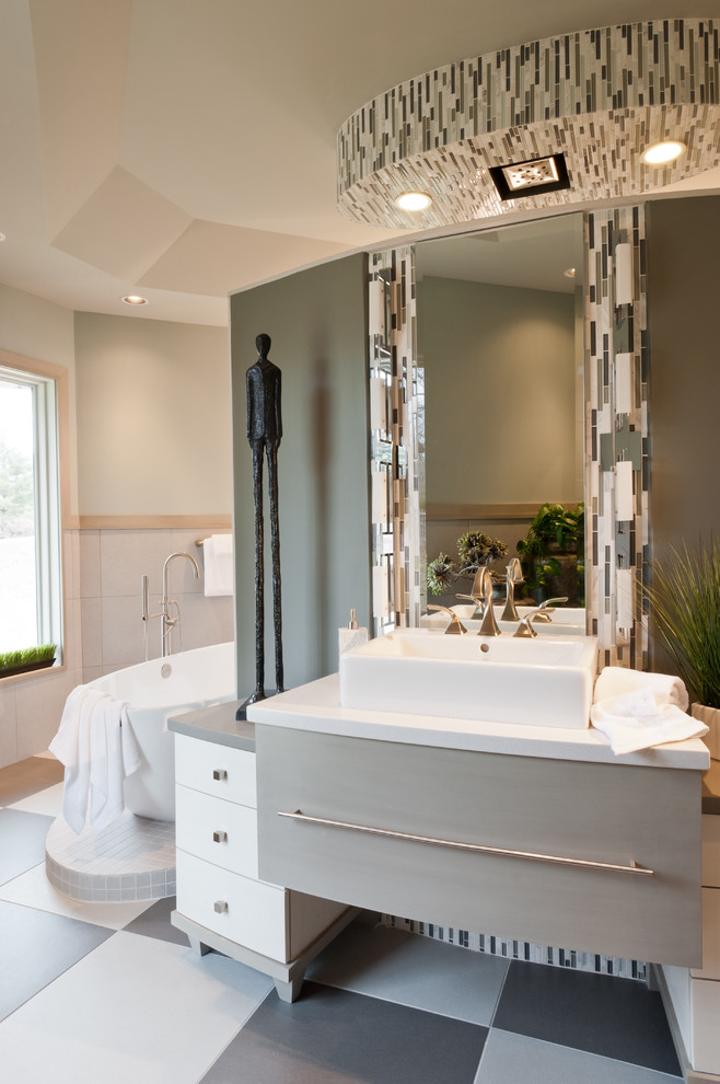 Inspiration for a contemporary bathroom in St Louis with a vessel sink and a freestanding tub.