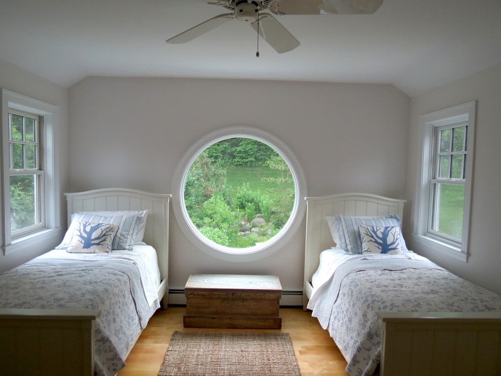 This is an example of a traditional guest bedroom in Boston with grey walls and medium hardwood floors.