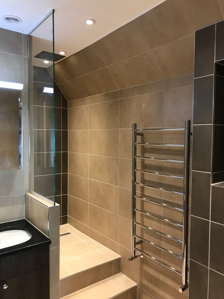 Inspiration for a mid-sized contemporary master wet room bathroom in London with brown cabinets, a wall-mount toilet, brown tile, porcelain tile, porcelain floors, a console sink, quartzite benchtops, beige floor, an open shower, flat-panel cabinets, a single vanity and a built-in vanity.