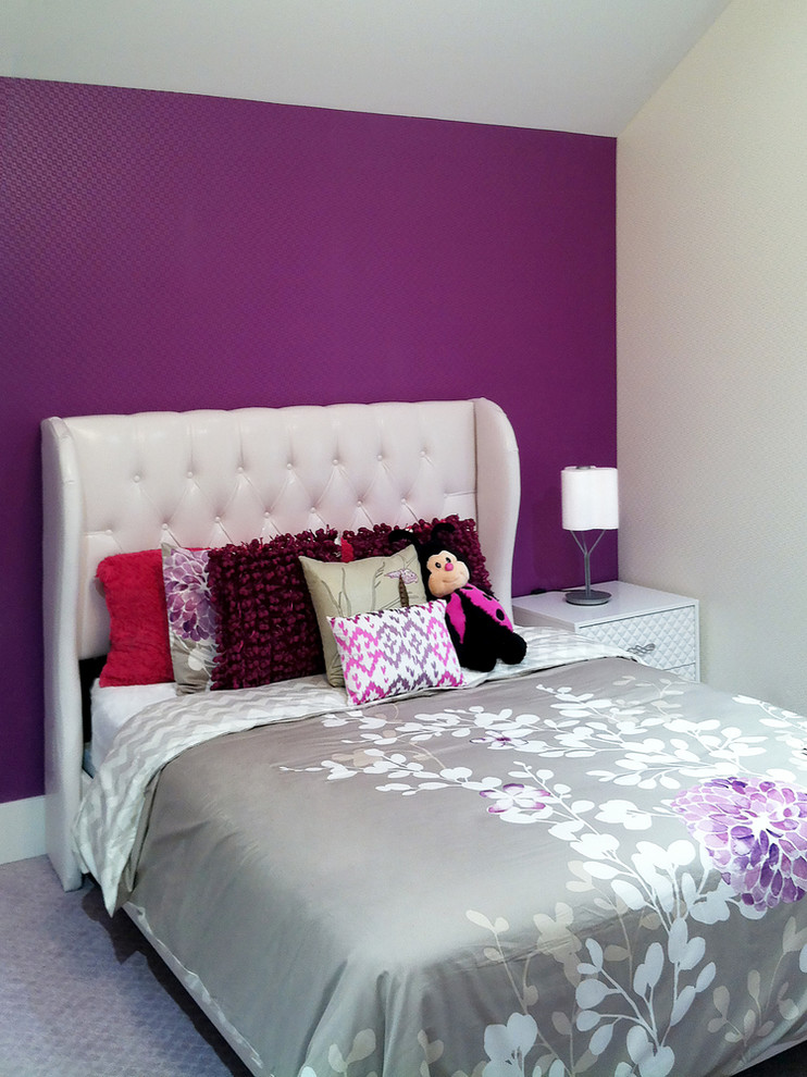This is an example of a mid-sized contemporary kids' bedroom for kids 4-10 years old and girls in New York with purple walls and carpet.