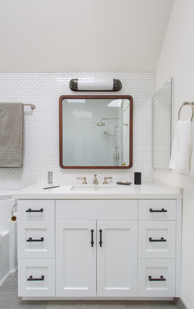 Photo of a beach style bathroom in San Francisco with shaker cabinets, white cabinets, white tile, ceramic tile, ceramic floors, an undermount sink, quartzite benchtops, grey floor and white benchtops.