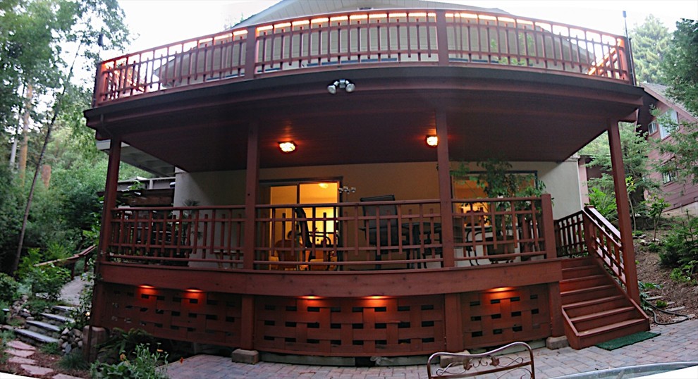 Example of a mid-sized classic backyard deck design with a roof extension