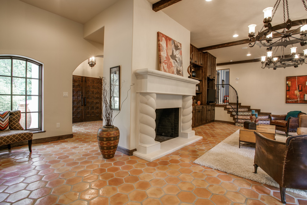 Large mediterranean formal open concept living room in Dallas with beige walls, terra-cotta floors, a standard fireplace, a stone fireplace surround and no tv.