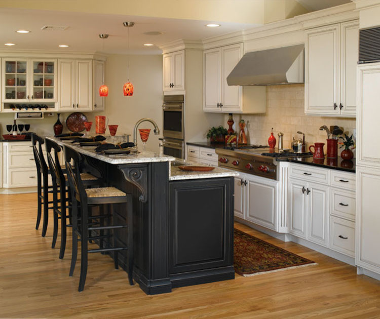 Mid-sized transitional l-shaped light wood floor and brown floor eat-in kitchen photo in Orange County with an undermount sink, raised-panel cabinets, white cabinets, granite countertops, beige backsplash, ceramic backsplash, stainless steel appliances and an island